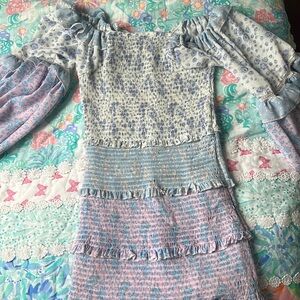 it’s a body tight dress with ruffles and multi color